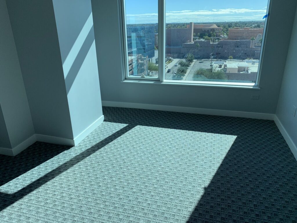 A room featuring new grey patterned carpet, expertly installed by Canyon State Flooring in Queen Creek, AZ.