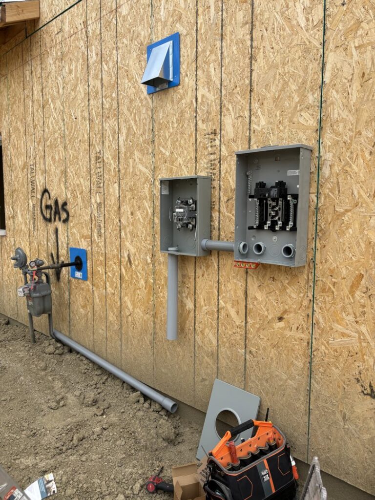 New home electrical panel and conduit installation on an exterior wall by Wilson Electrical Contractors in Orlando, FL.