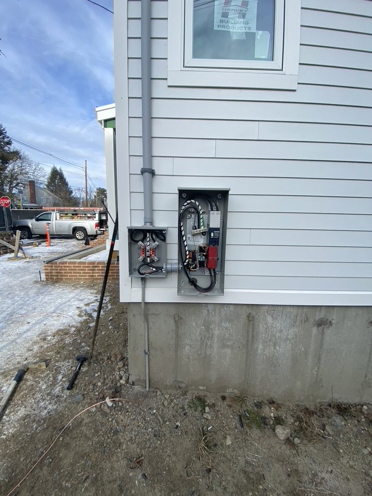 New home electrical service installation with meter and open panel by Empower Electrical, LLC in Fall River, MA