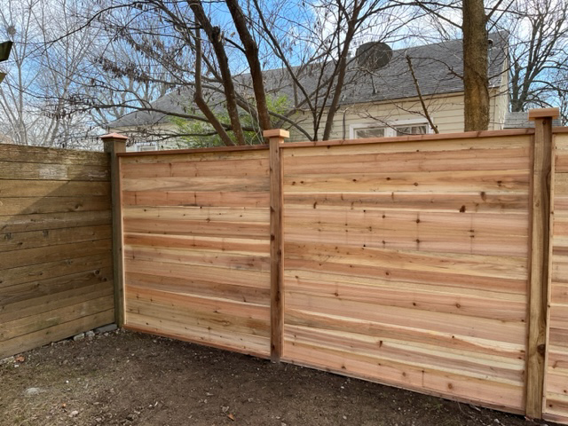 Newly installed horizontal cedar fence panels by Fence Solutions of NWA in Gravette, AR.