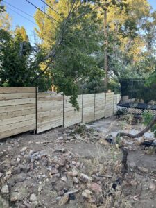 A newly installed modern horizontal slat wood fence in a backyard by This And That Fence in Reno, NV.