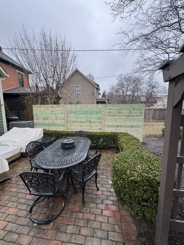 A new horizontal wood fence installed in a backyard patio area by Central Ohio Fence in Newark, OH.