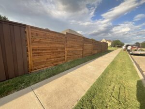 A newly installed horizontal wood fence running alongside a sidewalk, completed by G L Fence & Remodeling in Arlington, TX.