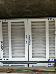 Two new, clean HVAC air filters (16x20x2) freshly installed in a system by GUS' HVAC Services in Canton, GA.