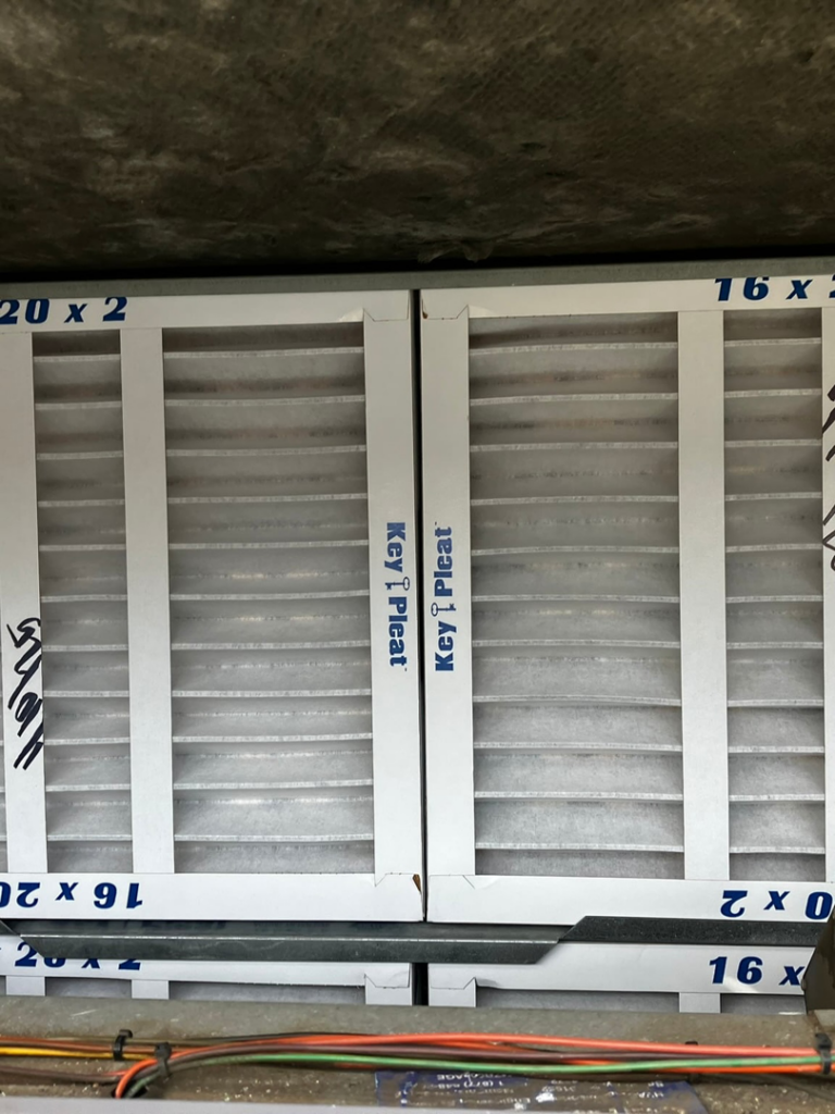 Two new, clean HVAC air filters (16x20x2) freshly installed in a system by GUS' HVAC Services in Canton, GA.