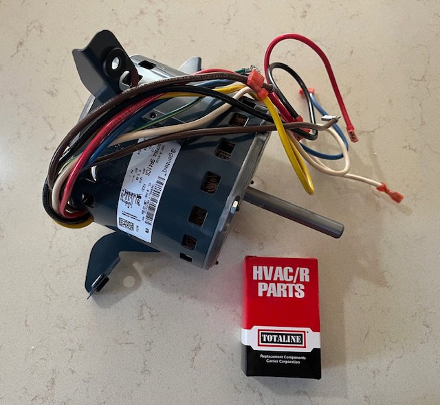 A new HVAC blower motor and a box of HVAC/R replacement parts, ready for installation by Bloomington Heating & Air in Bloomington, MN.