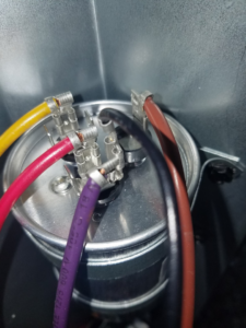 A newly installed HVAC capacitor with multiple colored wires connected, showcasing professional work by GUS' HVAC Services in Canton, GA.