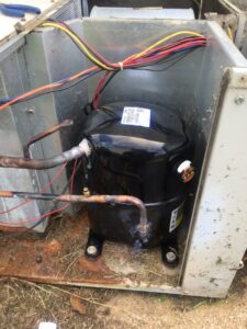 A new HVAC compressor being installed inside an outdoor unit by Johnson's Heating and Cooling in Clarksville, TN.