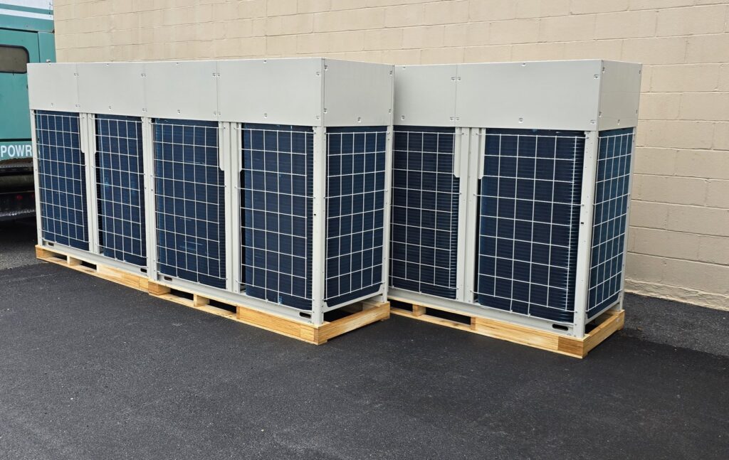 New outdoor HVAC condenser units on pallets, ready for installation by Clean Air Quality Service Inc in Hawthorne, NY