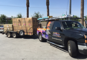 A Child Air Conditioning & Heating Inc. truck delivering new HVAC condenser units on a trailer in Mesa, AZ.