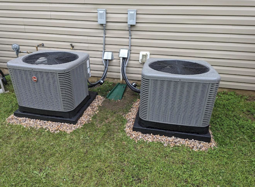 Two new HVAC condenser units installed outside a home by Elite Air and Heat of Summerville, SC.