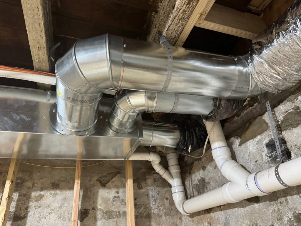 New HVAC ductwork and plumbing pipes installed in a residential basement by J & J Heating and Cooling, Inc. in Lancaster, PA.