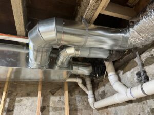 New HVAC ductwork and plumbing pipes installed in a residential basement by J & J Heating and Cooling, Inc. in Lancaster, PA.