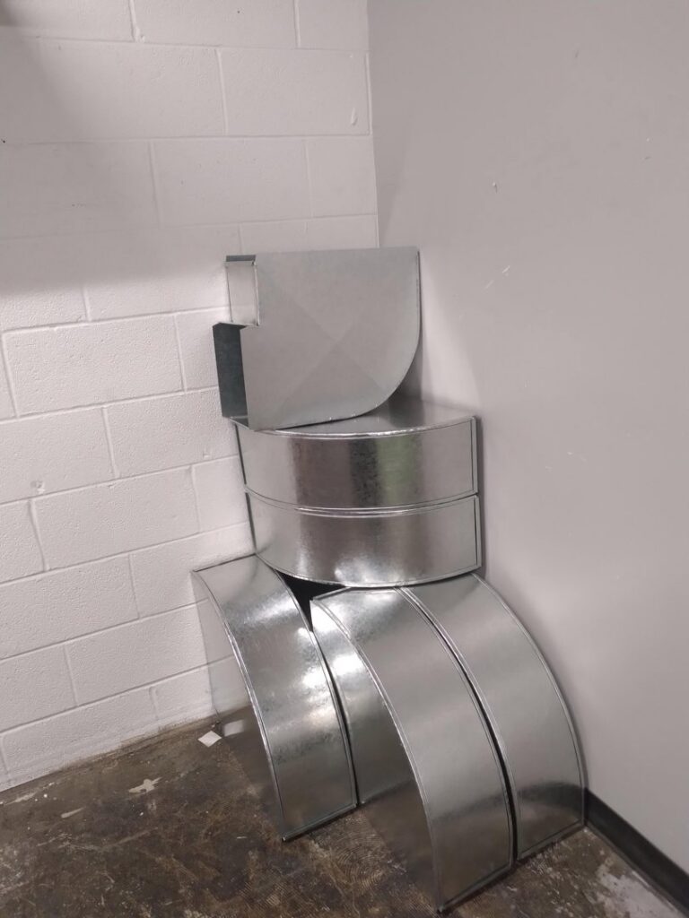 A stack of new galvanized steel ductwork components for HVAC installation by Epic Heating & Cooling in Wichita, KS.