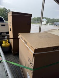 New HVAC equipment in boxes, along with a refrigerant tank, being delivered by Southern Climate Pros for installation in Jasper, AL.