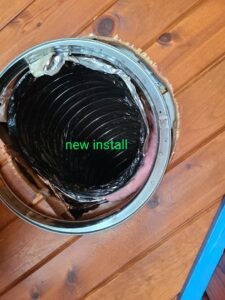 New HVAC flexible ductwork installation visible through a round opening in a wooden ceiling by Rivertech Heating & Air Conditioning in Chattanooga, TN.