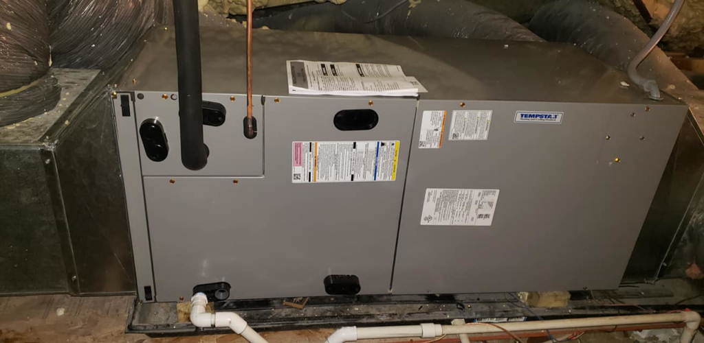 A newly installed indoor HVAC furnace or air handler unit with ductwork by Hobart Heating & Cooling Inc. in East Peoria, IL.
