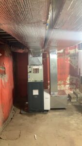 A new HVAC furnace and ductwork installation in a utility room by Freedom Air Mechanical Contractors LLC in Everett, MA.