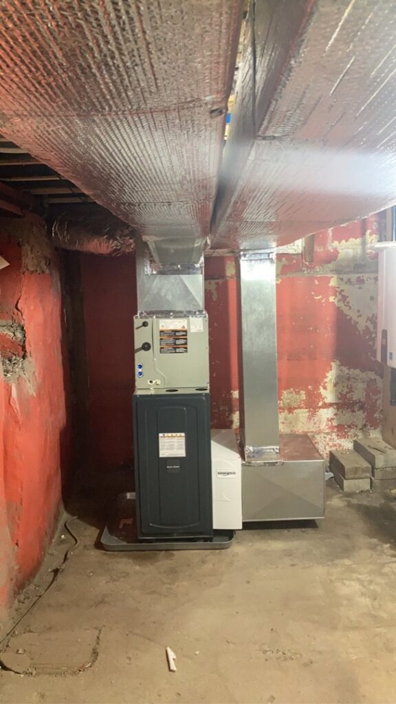 A new HVAC furnace and ductwork installation in a utility room by Freedom Air Mechanical Contractors LLC in Everett, MA.