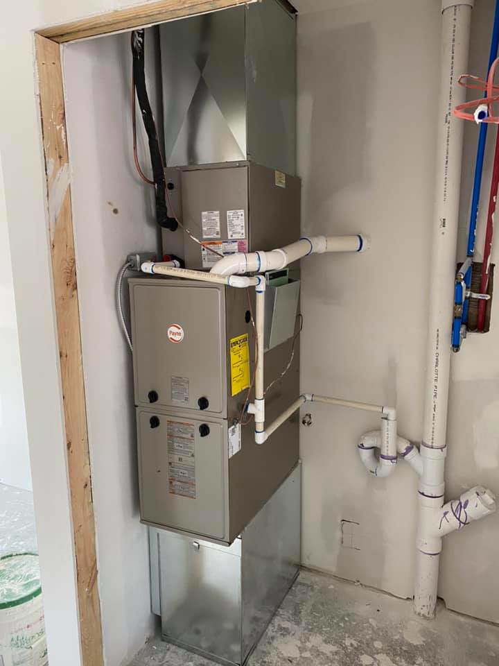 A new HVAC furnace and air handler unit with ductwork installed in a residential space by R. Jones Heating & Cooling in Indianapolis, IN.