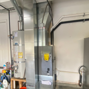 A newly installed HVAC furnace and water heater system with ductwork by Arctic Heating And Cooling in Chesapeake, VA.