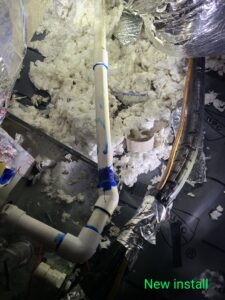 Close-up of new HVAC piping, drainage, and insulation being installed in an attic by Rivertech Heating & Air Conditioning in Chattanooga, TN.