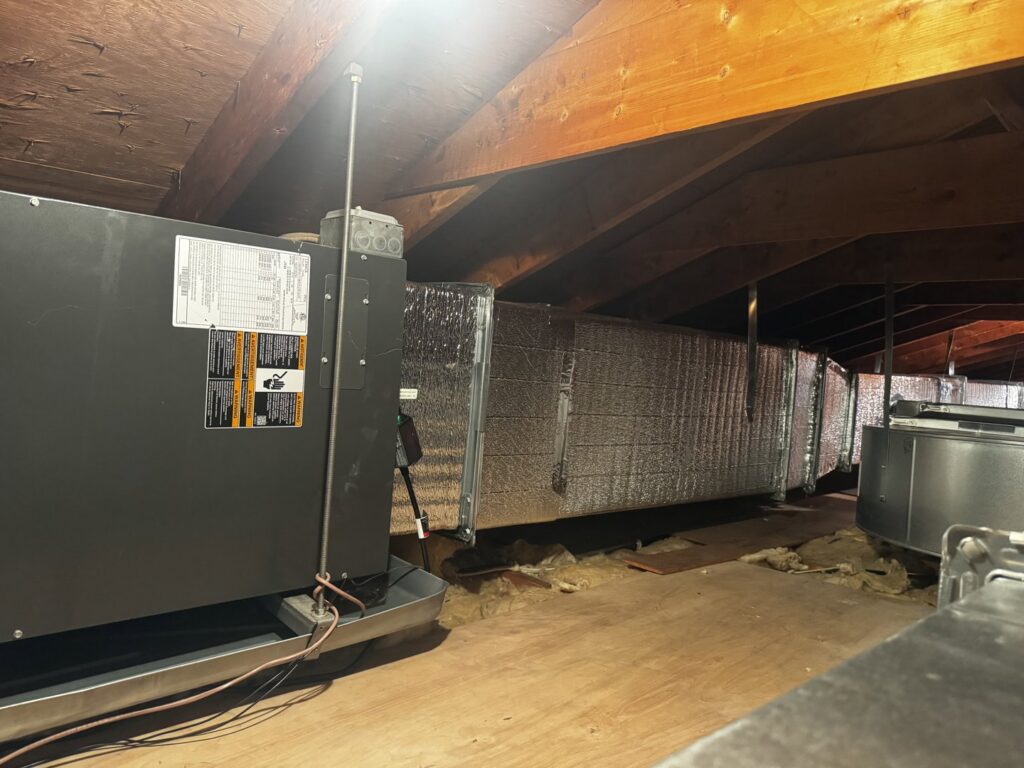 A newly installed HVAC system with insulated ducts in an attic by PureTemp Heating and Cooling in Salem, NH.