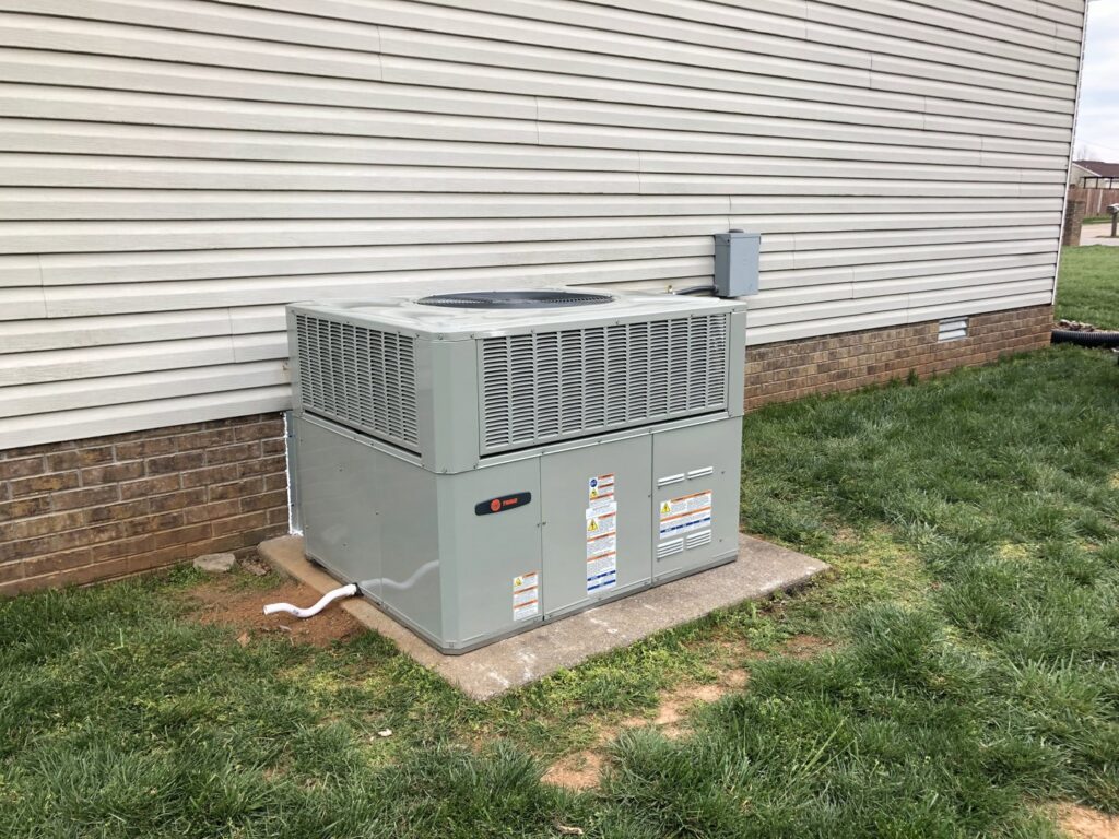 A newly installed outdoor HVAC unit next to a residential home by Eaton Companies LLC in Clarksville, TN.
