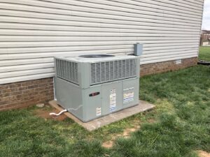 A newly installed outdoor HVAC unit next to a residential home by Eaton Companies LLC in Clarksville, TN.