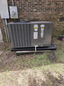 A newly installed outdoor HVAC unit next to a brick building by GS Heating and Air LLC in West Columbia, SC