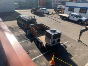 A new HVAC unit loaded onto a trailer for delivery by 413 Services in Piedmont, SD