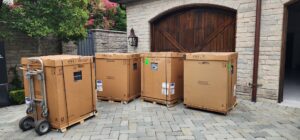 Several new boxed HVAC units, likely furnaces or air conditioners, ready for installation by Harlen Johnson Heating & Air in Dallas, TX.