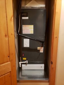 A new indoor HVAC air handler installed in a utility closet by Arrow Pro Services in Gilbert, AZ