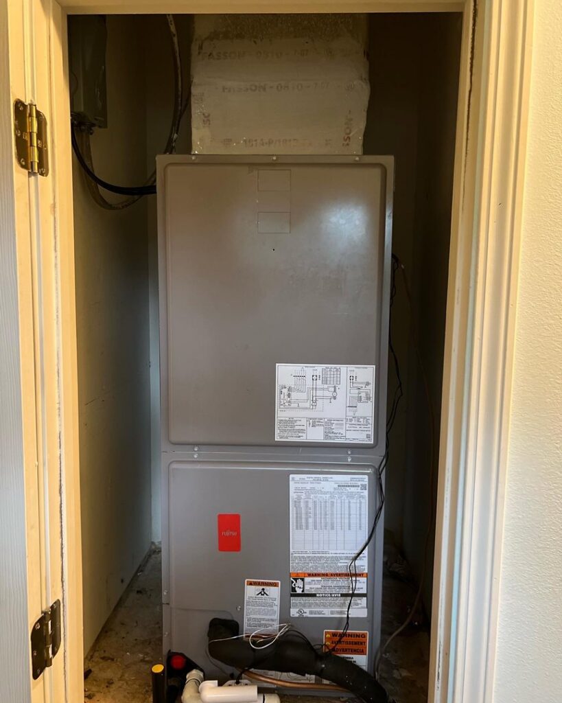 A new indoor HVAC system, likely an air handler, installed in a utility closet by Circle L Heating and Cooling LLC in Atmore, AL.