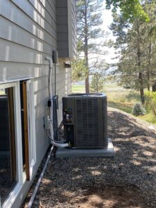 A newly installed Lennox AC unit next to a residential home by Central Heating & Air Conditioning in Billings, MT