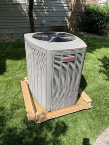 A new Lennox air conditioning unit placed on grass, ready for installation by Davenport Service Company in Olathe, KS