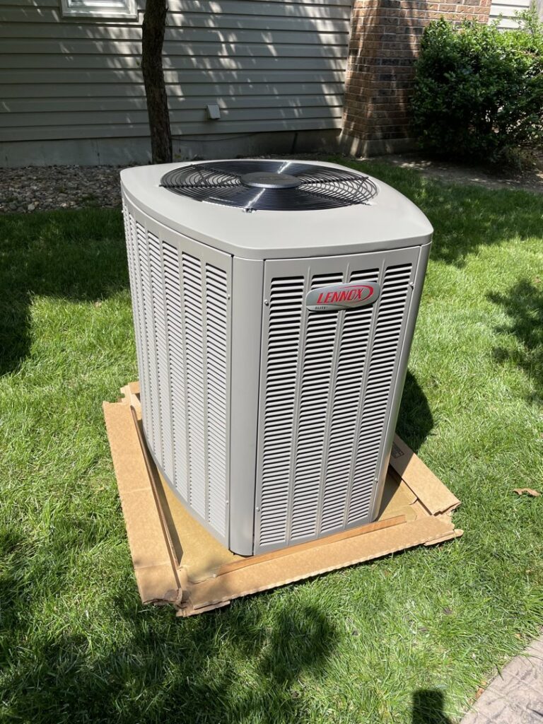 A new Lennox air conditioning unit placed on grass, ready for installation by Davenport Service Company in Olathe, KS