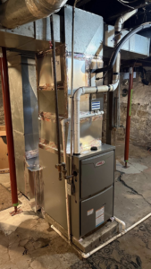 A newly installed Lennox furnace and ductwork in a basement by Comfort Home Services in Sugar Creek, MO