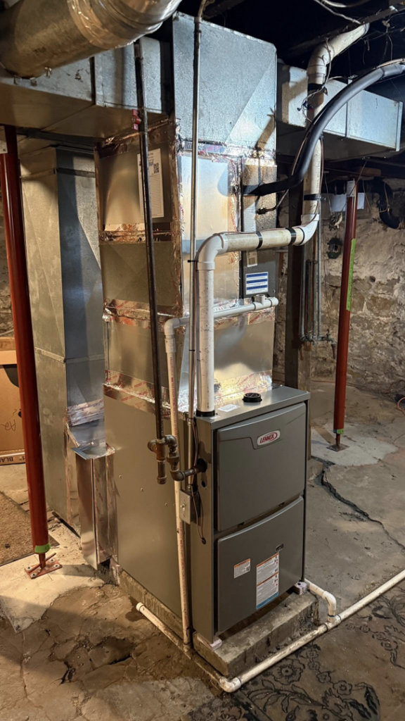 A newly installed Lennox furnace and ductwork in a basement by Comfort Home Services in Sugar Creek, MO