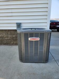 A newly installed Lennox outdoor air conditioning unit on a concrete pad by Heating and Cooling Drs of Waukesha, Pewaukee, and Delafield, Waukesha, WI.