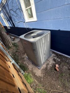 A newly installed Lennox outdoor air conditioning unit next to a residential home by One Hour Air Conditioning & Heating of Fort Worth, TX.
