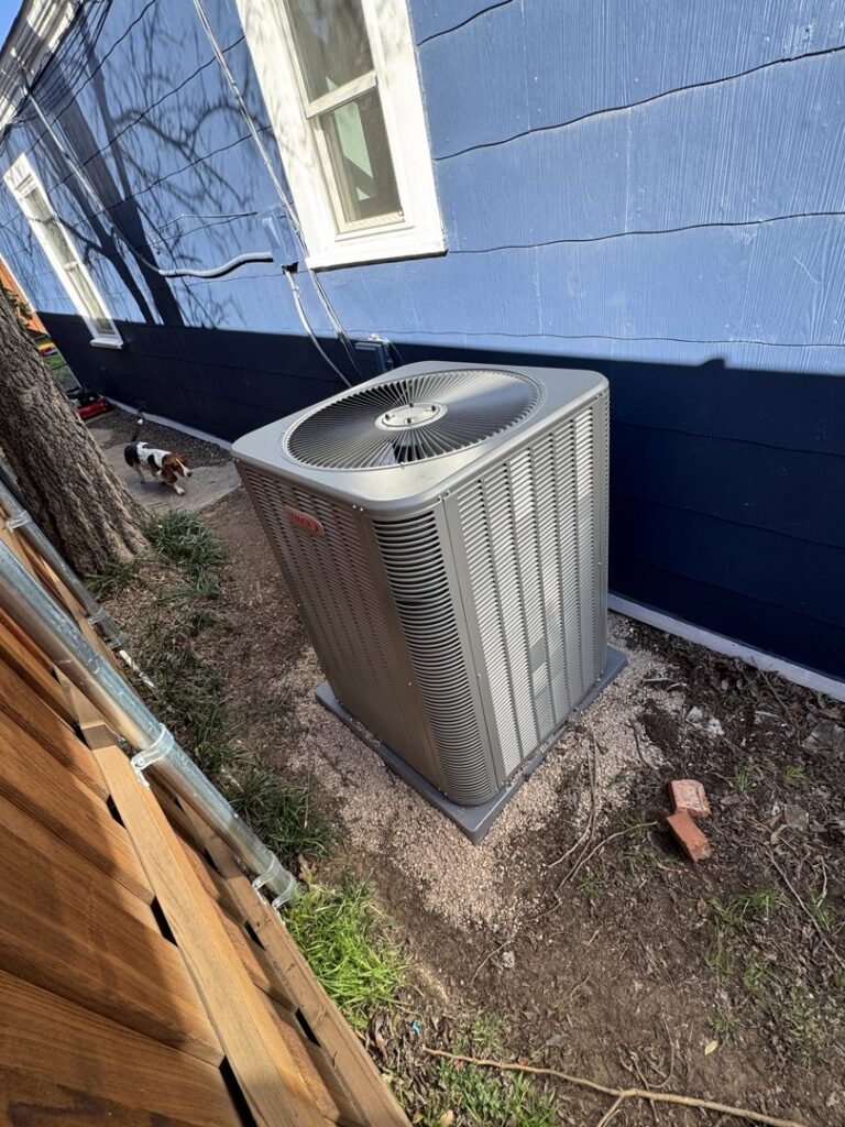A newly installed Lennox outdoor air conditioning unit next to a residential home by One Hour Air Conditioning & Heating of Fort Worth, TX.