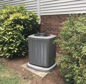 A newly installed Lennox outdoor HVAC condenser unit next to a residential home by Systematic Heating & Air in Winston-Salem, NC.