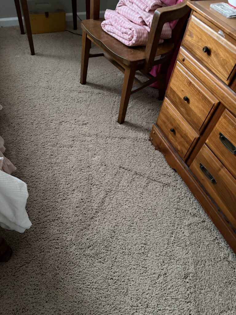 A cozy bedroom featuring a new light brown carpet installation by Kevin's Carpets of Lexington and Georgetown, KY.