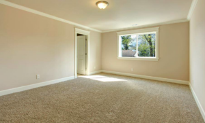 A newly installed light brown carpet in an empty room by Flooring Cleveland - Ohio City in Cleveland, OH.
