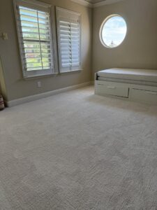 A spacious room featuring new, light-colored carpet expertly installed by Peek's Floor Co. in Dallas, TX.