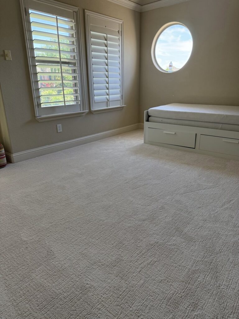 A spacious room featuring new, light-colored carpet expertly installed by Peek's Floor Co. in Dallas, TX.
