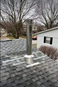A newly installed metal chimney system on a residential roof by Chimney Mechanix of Indiana in Lafayette, IN.