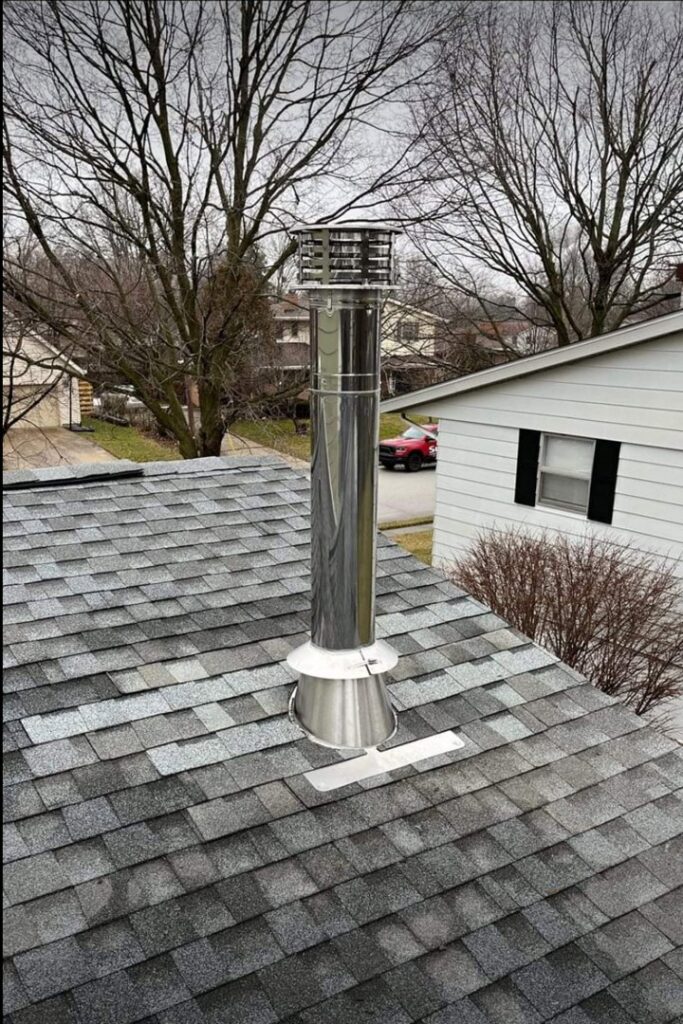 A newly installed metal chimney system on a residential roof by Chimney Mechanix of Indiana in Lafayette, IN.
