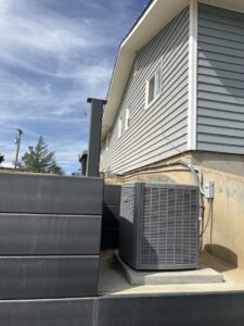 A newly installed outdoor AC condenser unit by EPCTL Heating and Cooling in Byers, CO.